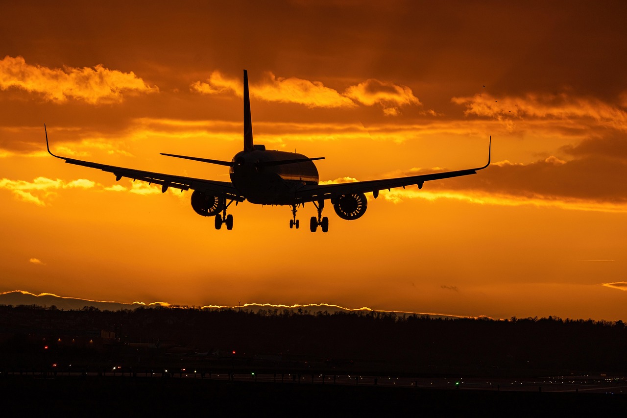 airplane wing above clouds booking tickets